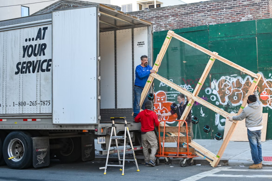 movers removing a window from a truck