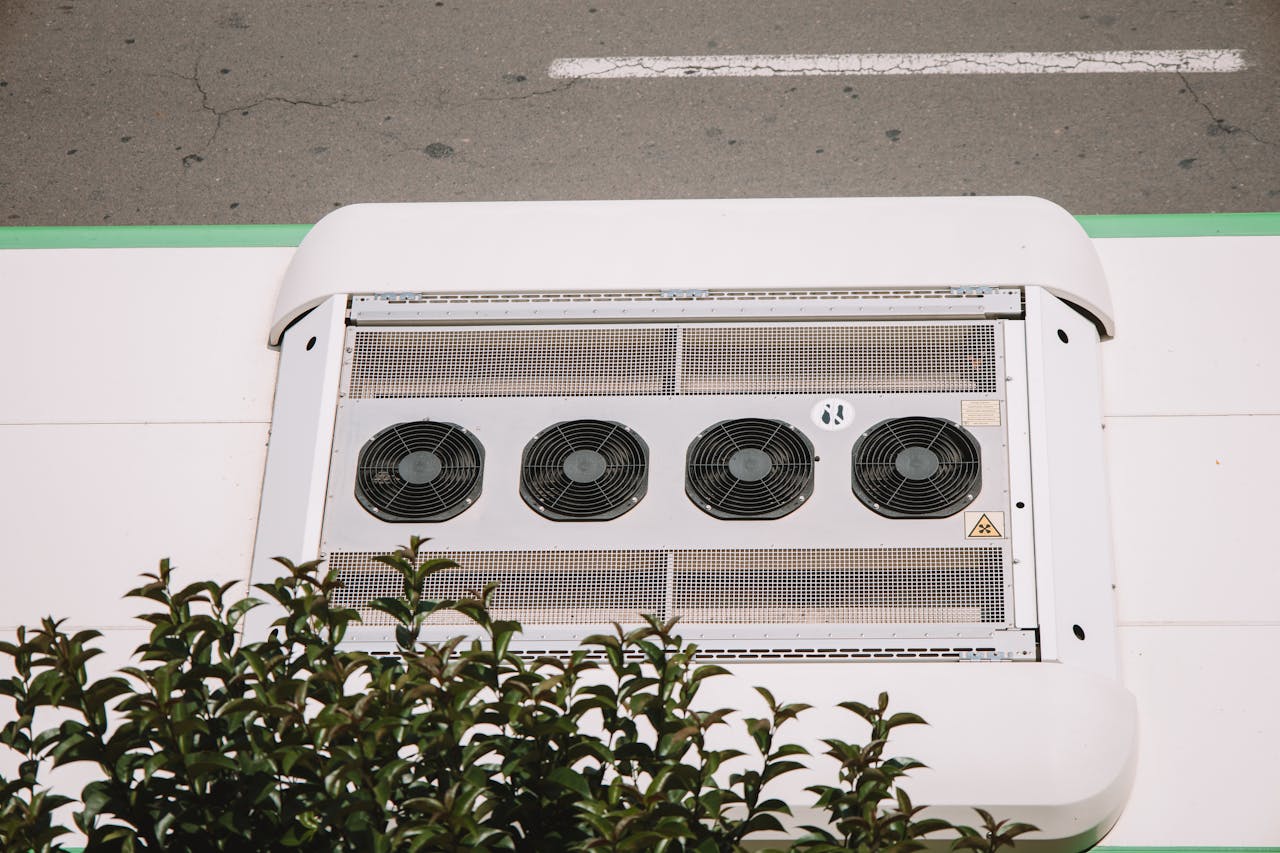 Large commercial air conditioner unit mounted outside a building. Image by Pexels