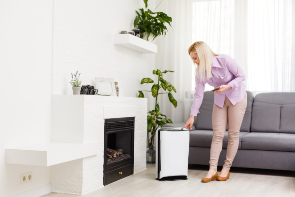 Person in livingroom in front of a fireplace