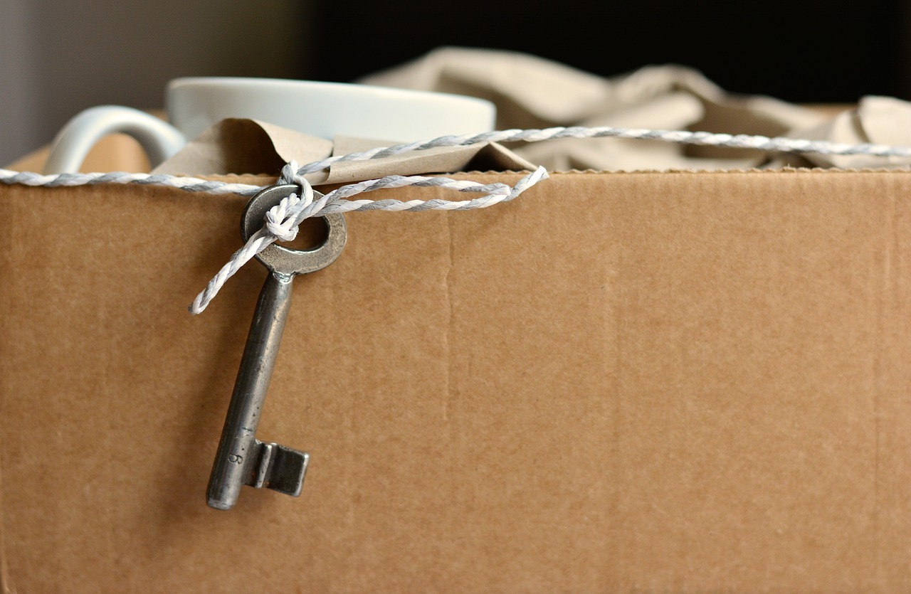 Cardboard box with a key haning on a string