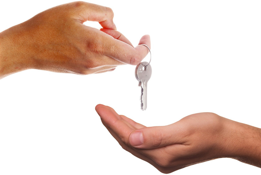 person handing over keys
