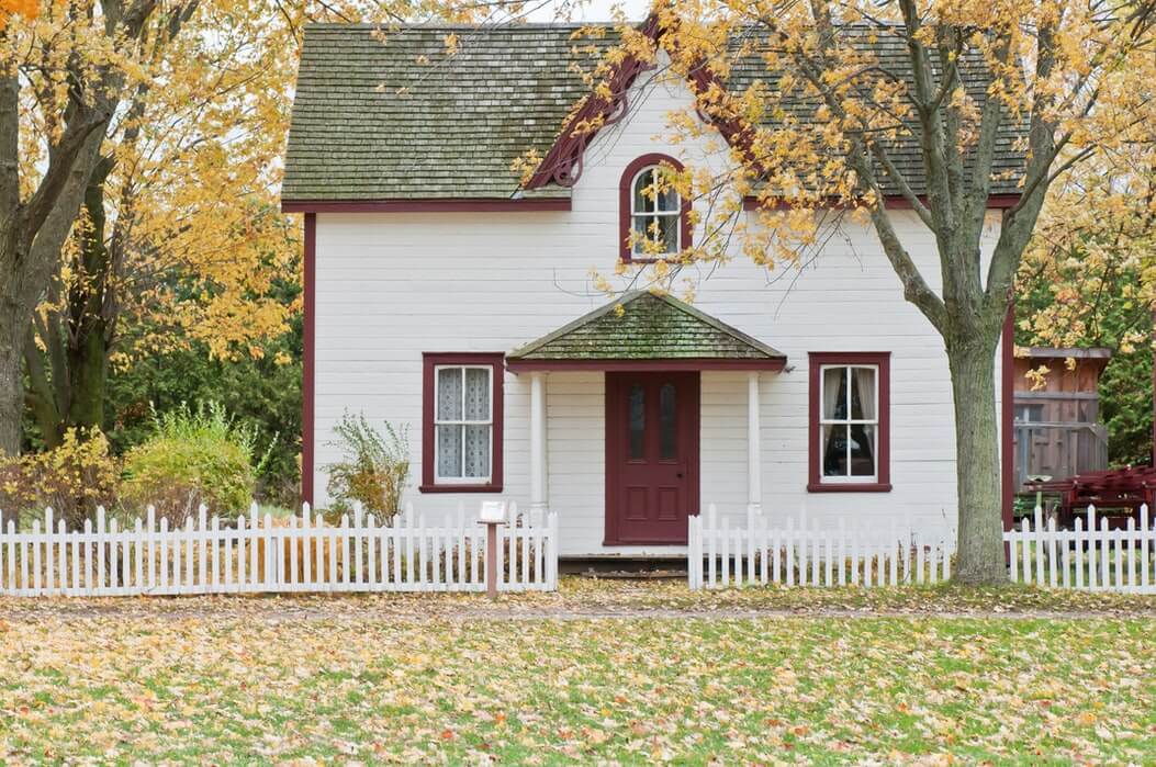 white house with moss on the roof