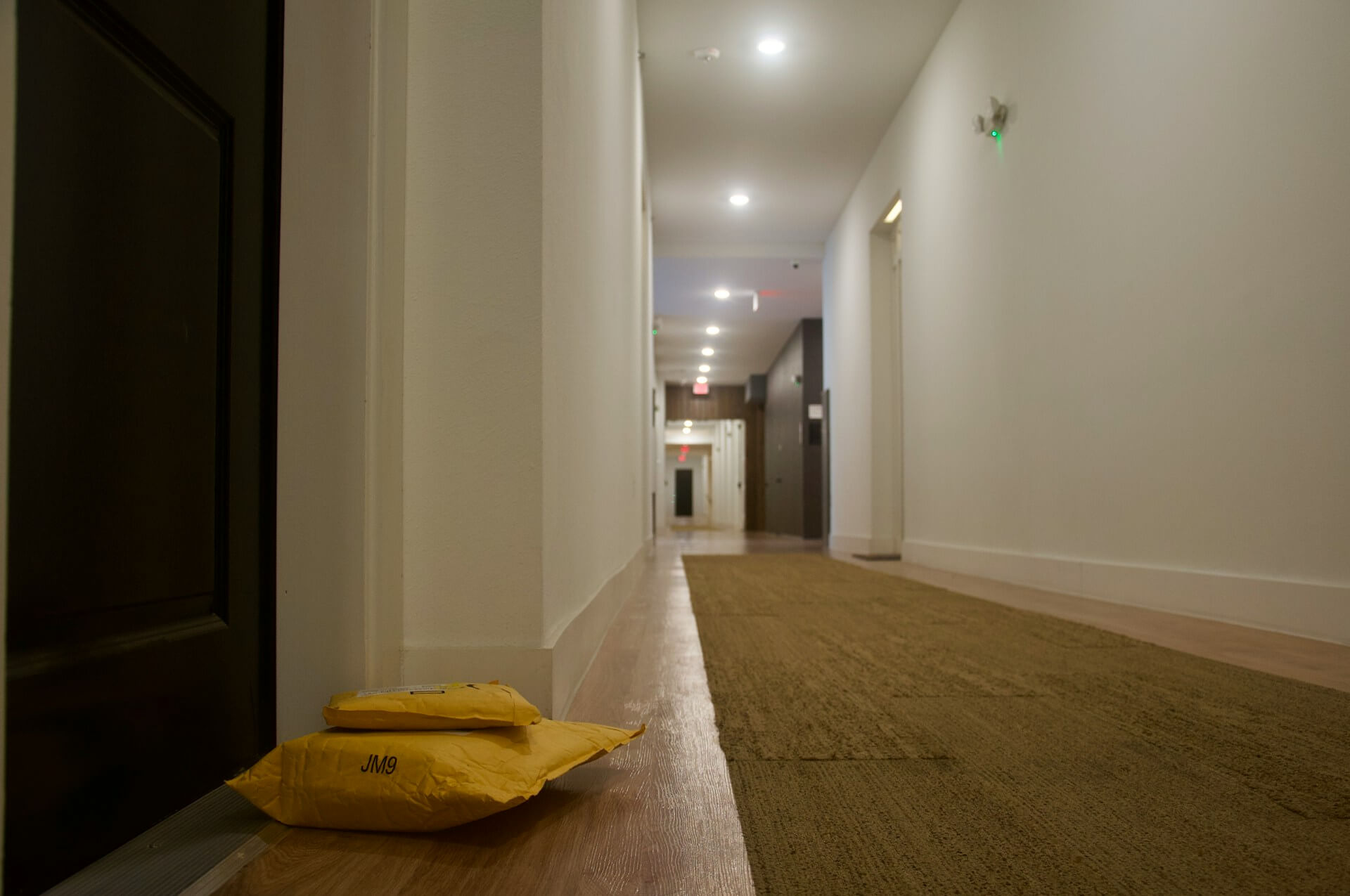 Packages outside a door in an apartment building. Image by Unsplash