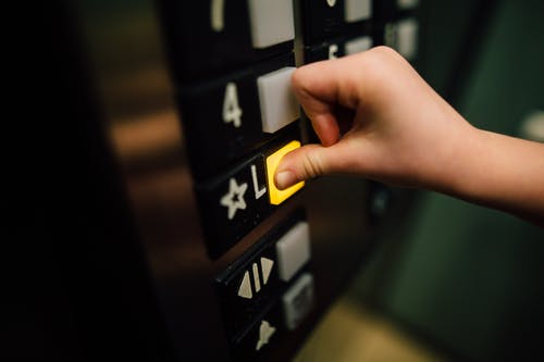 Pressing a button in an elevator