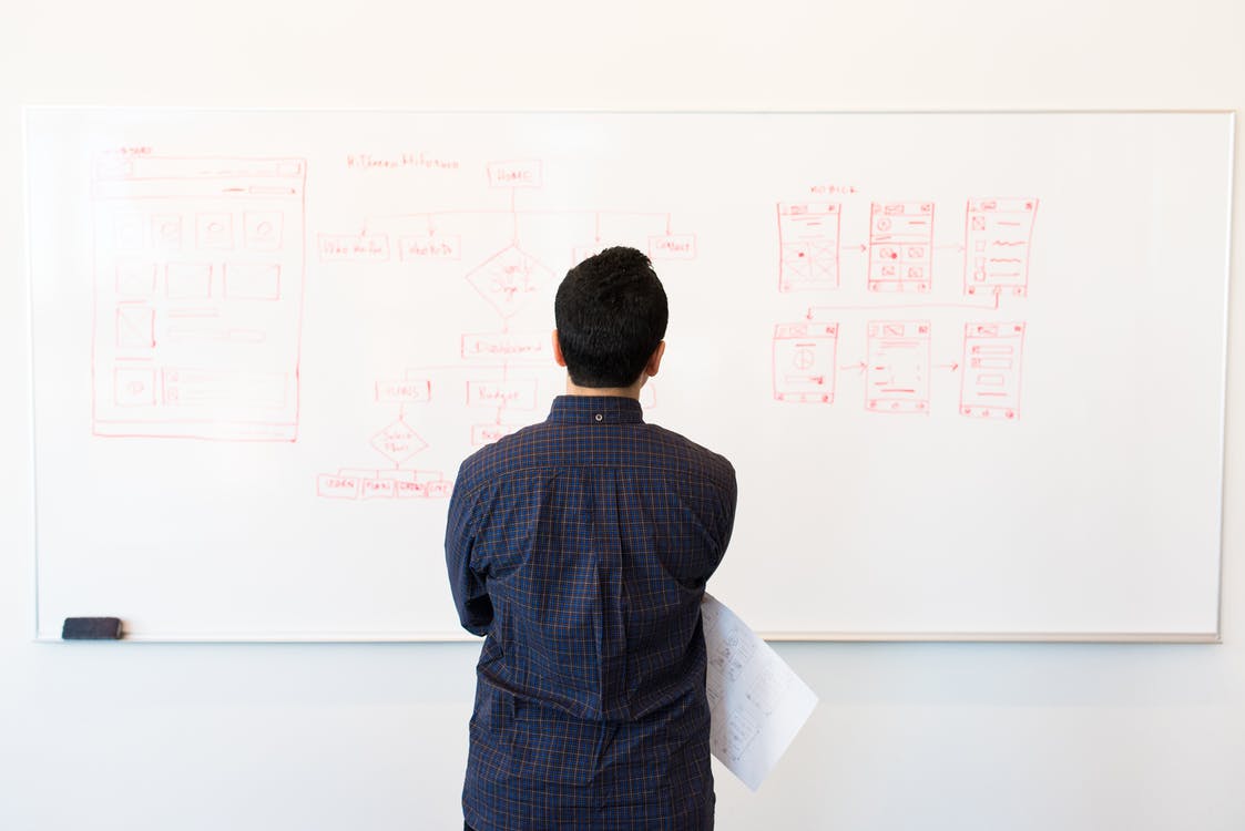 person looking at a wite board