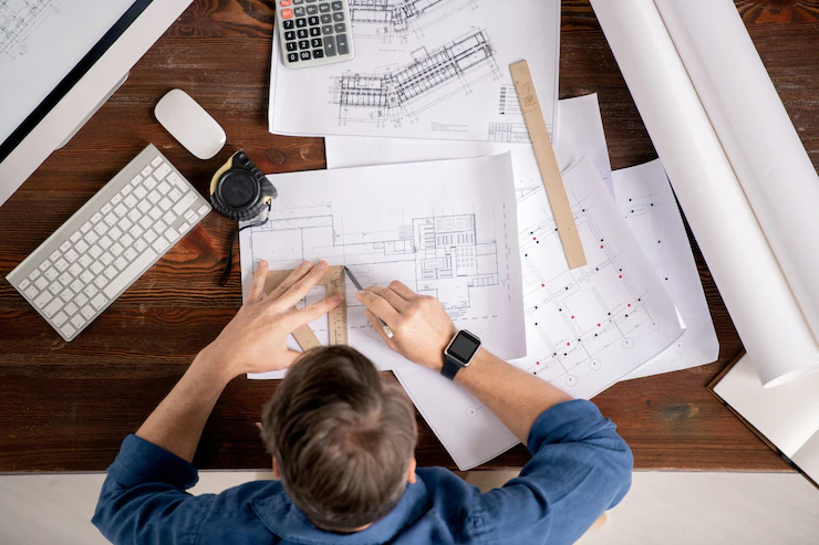 person working on a construciton plan, architect