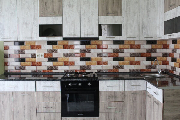 kitchen with colorful backsplash