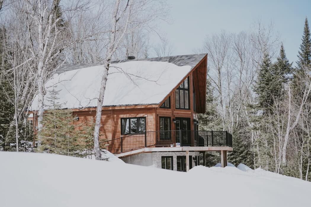 snow on top of a roof of a house