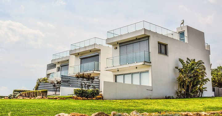 Large white house with numerous balconies