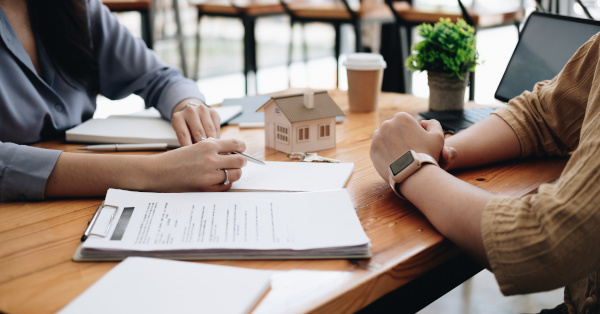 person going over paperwork with another person