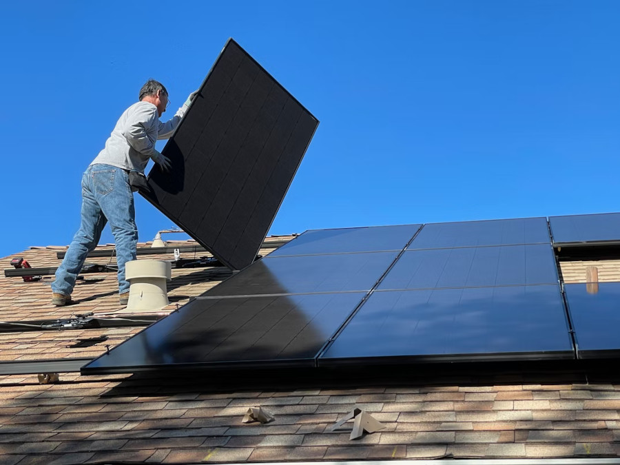 person installing solar panels