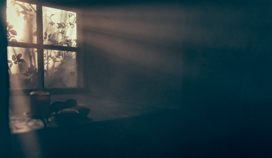 Dark basement room with a window bringing in some light.