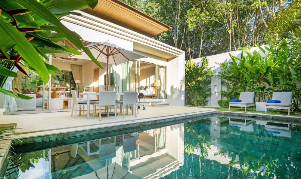 House with large windows overlooking a pool