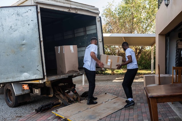 movers holding boxes