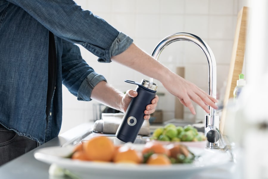 Person filling a bottle with water