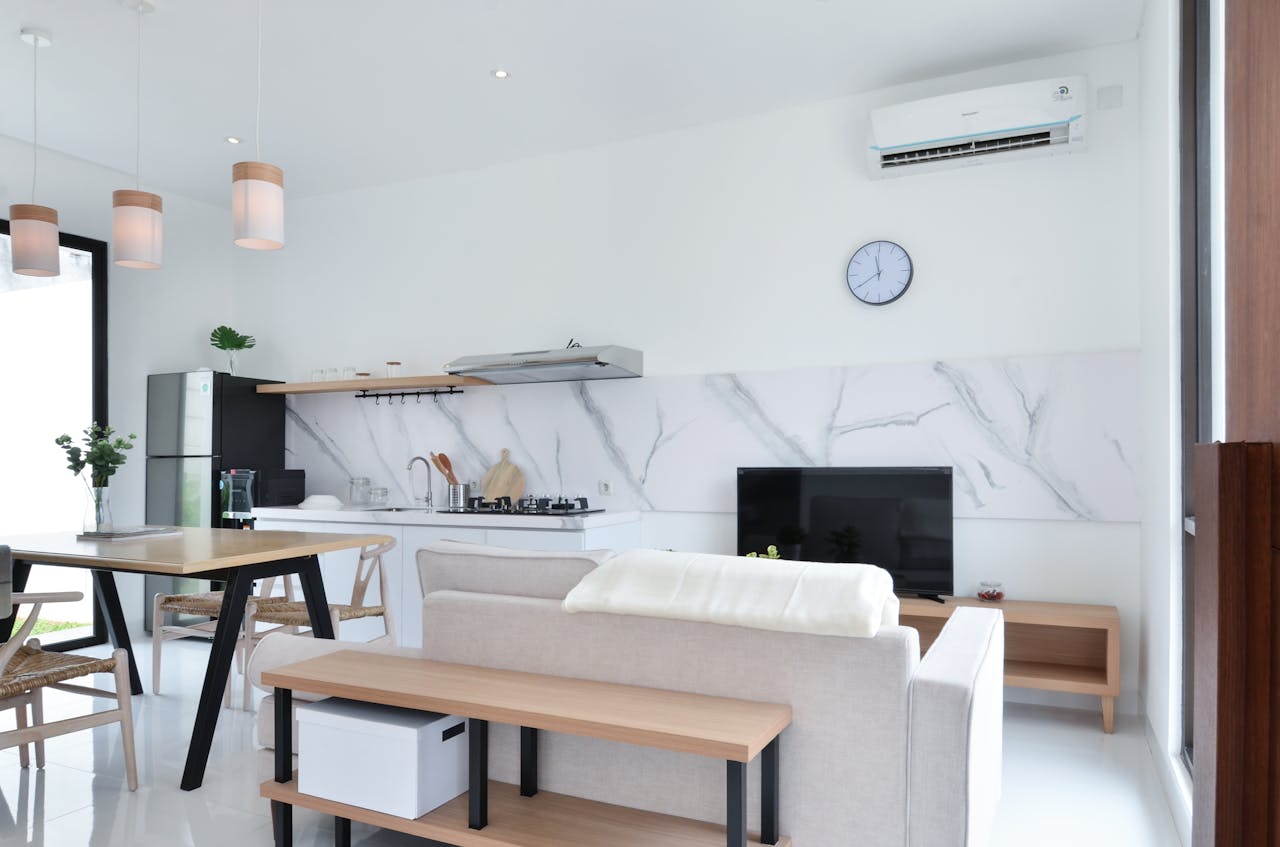 Livingroom kitchen combo. Air conditioner unit on wall