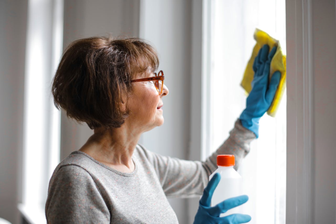 Person cleaning a window. Image by Pexels