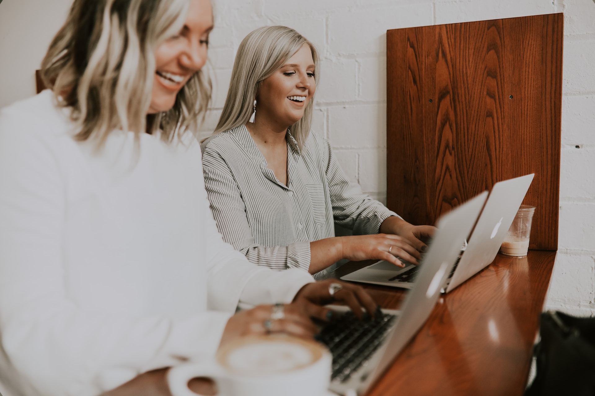 two people typing on laptops