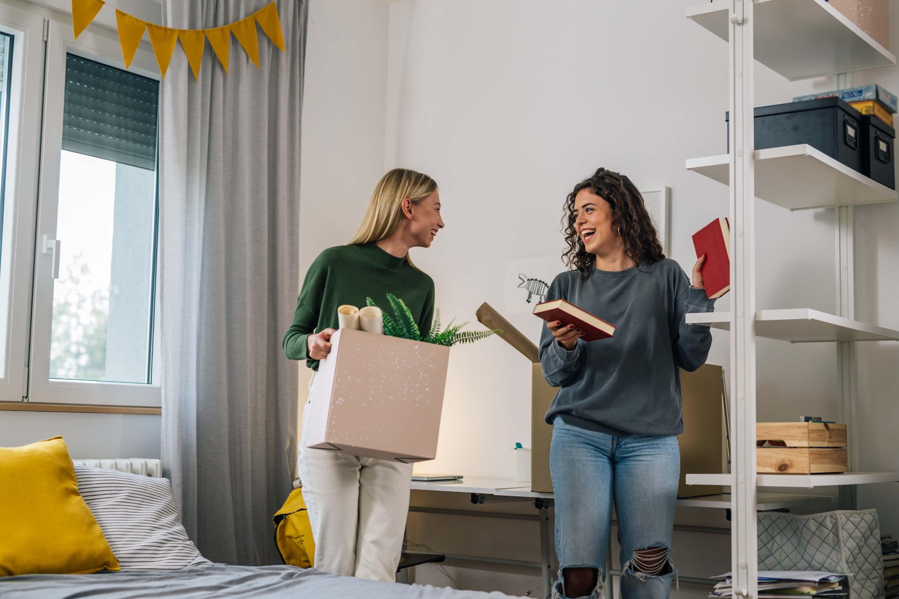 2 students with moving boxes