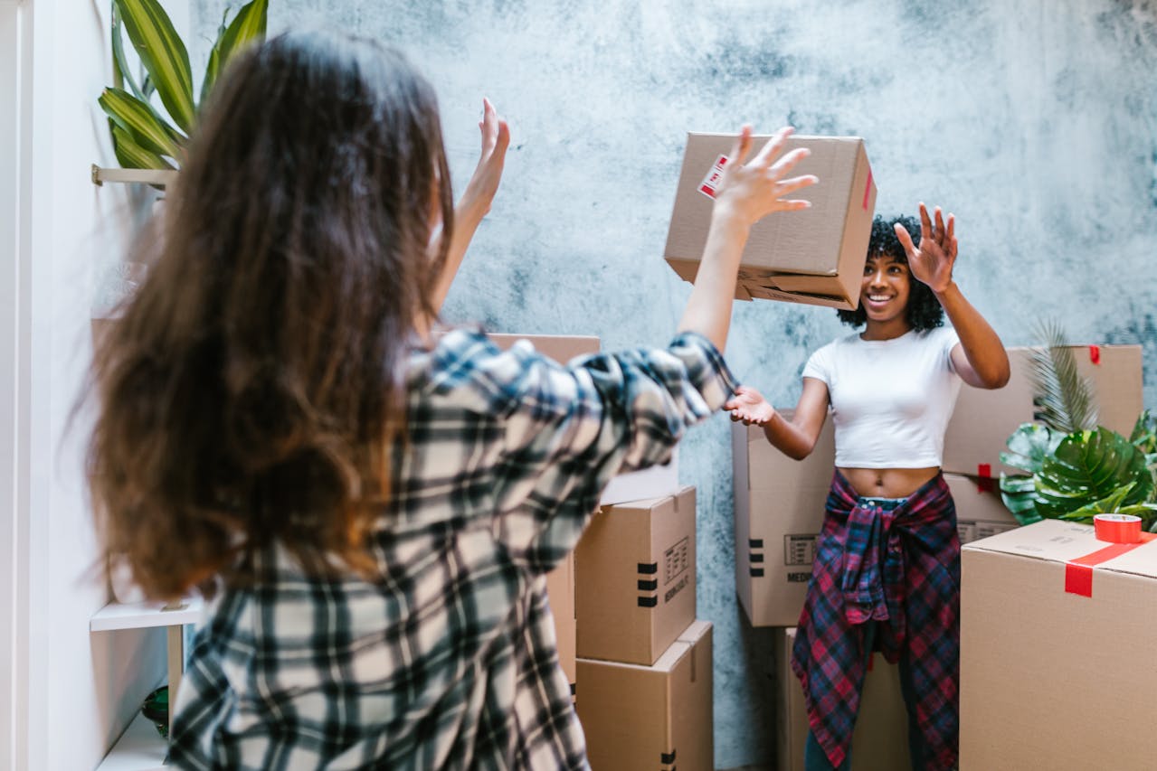 person throwing a box to another person
