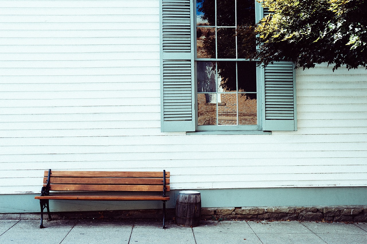 Bench in front of a white house