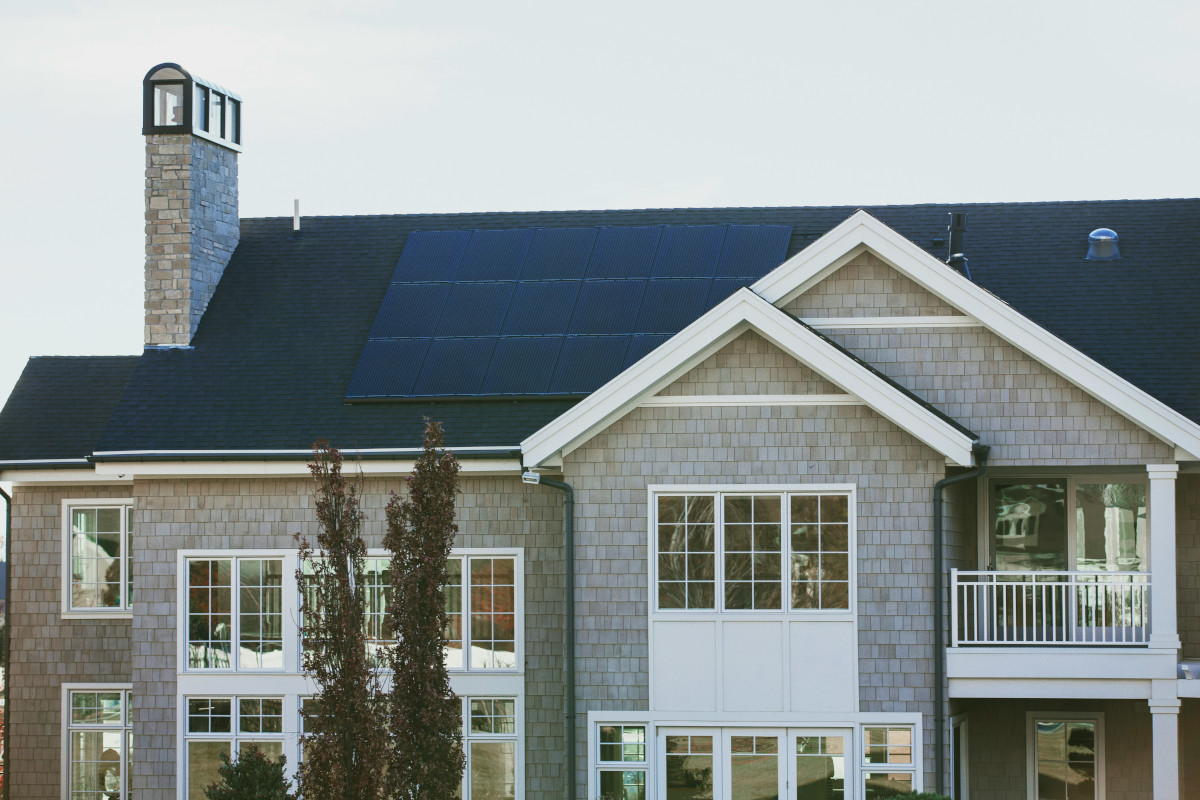 person installing solar panels on a house