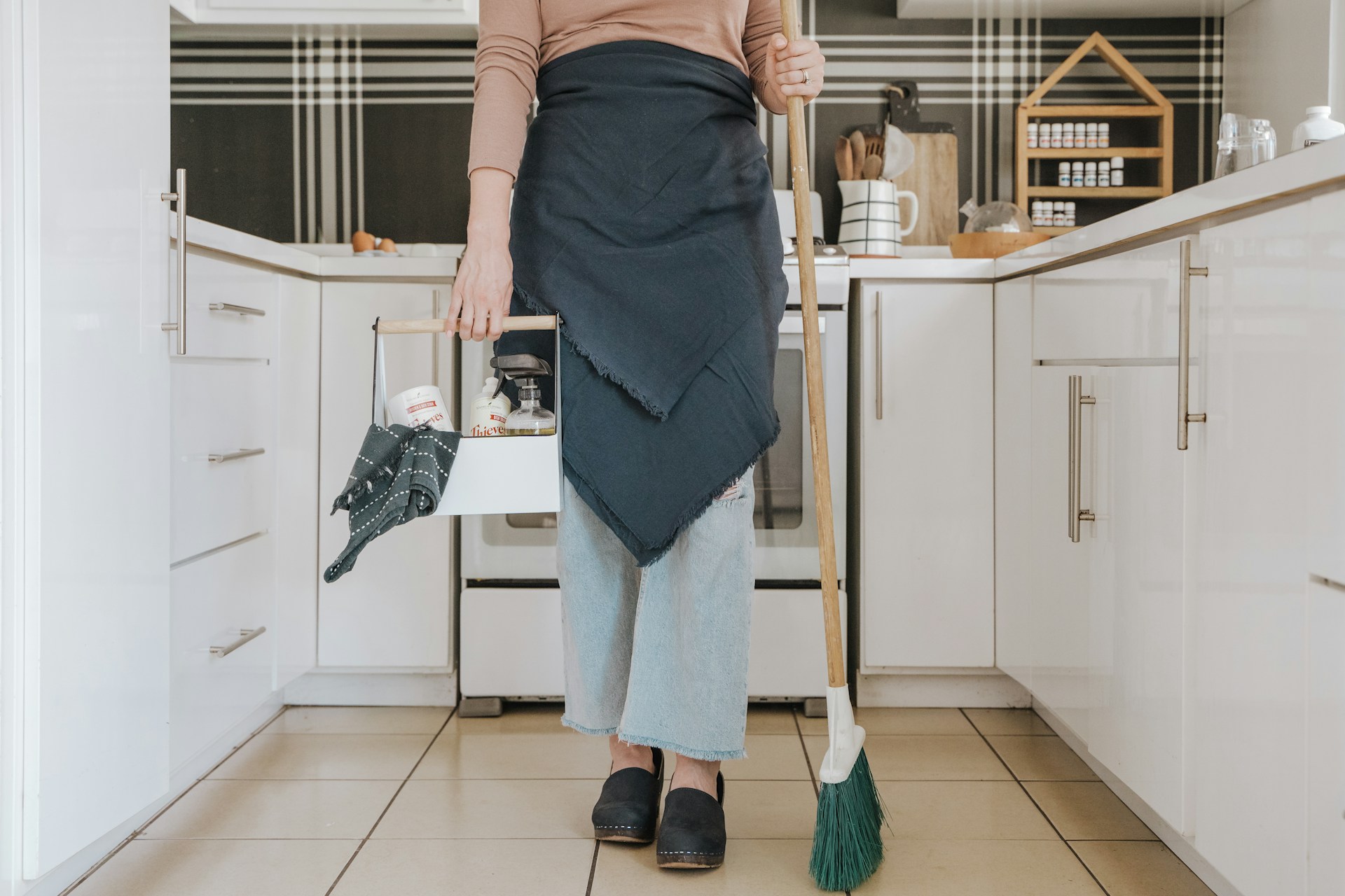Person with claning supplies. Image by Unsplash