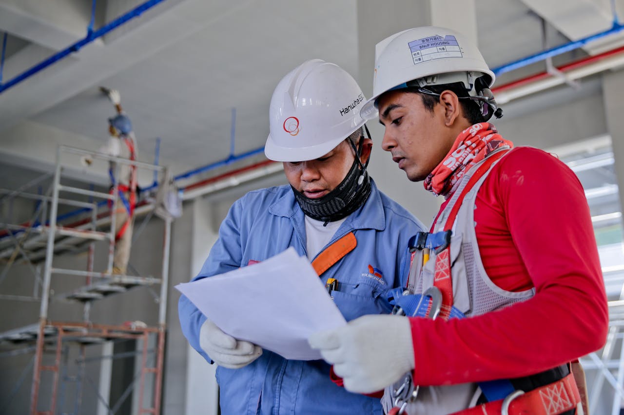Construction workers looking at papers