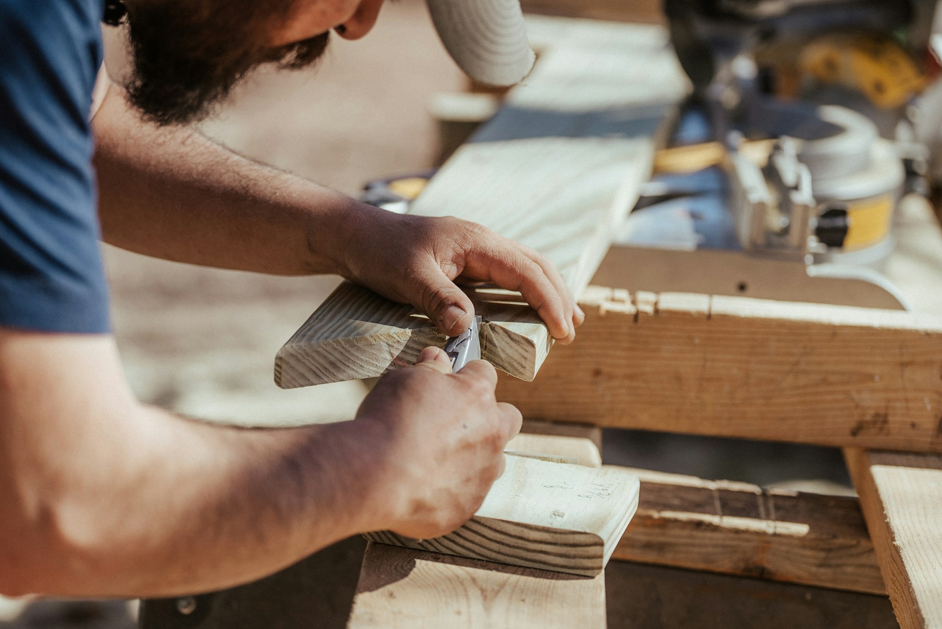 Person working on a piece of wood. Image by Unsplash