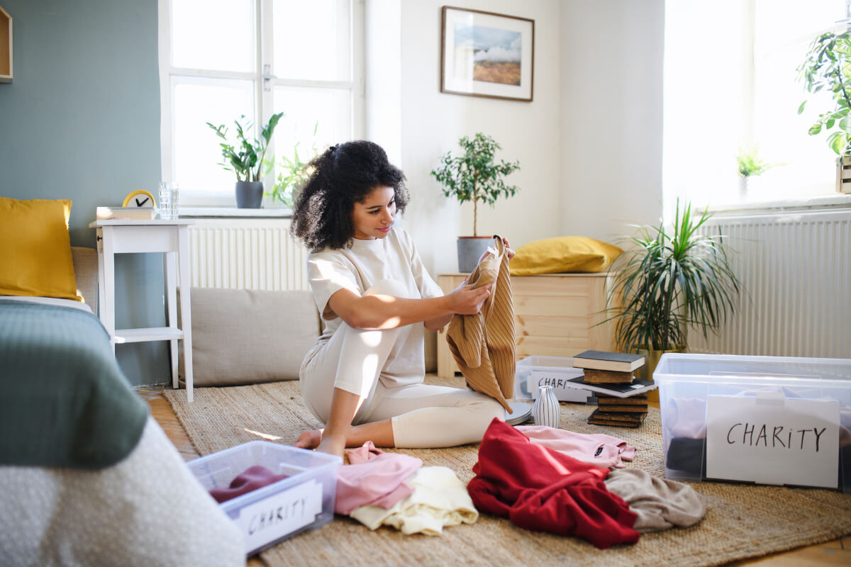 person sorting, donating clothing