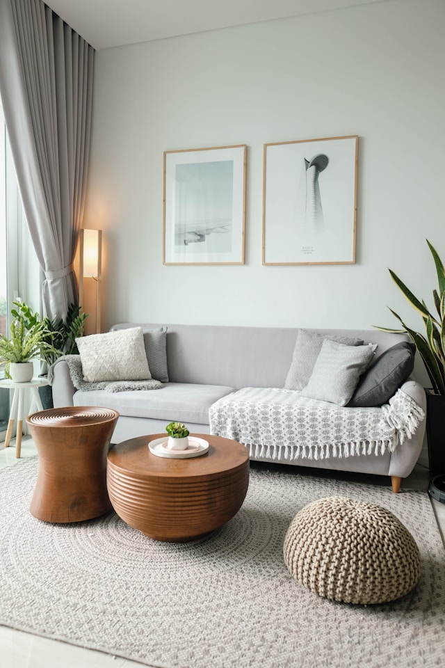 Calm minimalist living room with natural light, wooden furniture, and indoor plants. Image by Unsplash