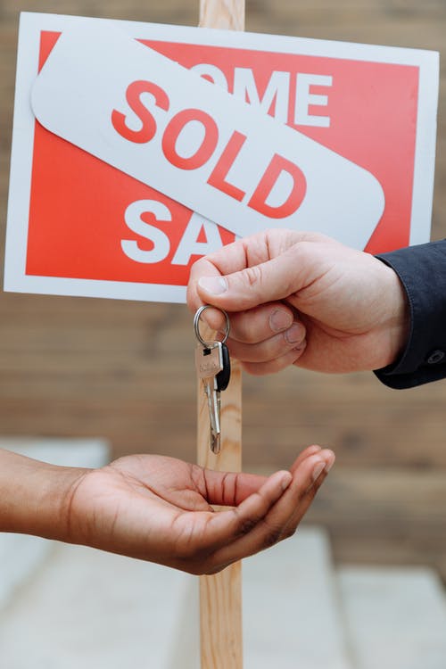 sold sign, handing over keys