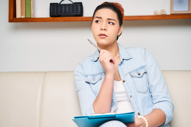 Person sitting on a couch, thinking