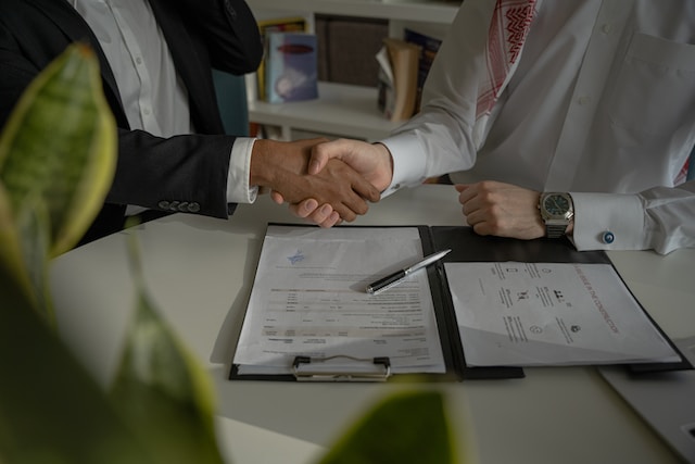 People doing paperwork, shaking hands