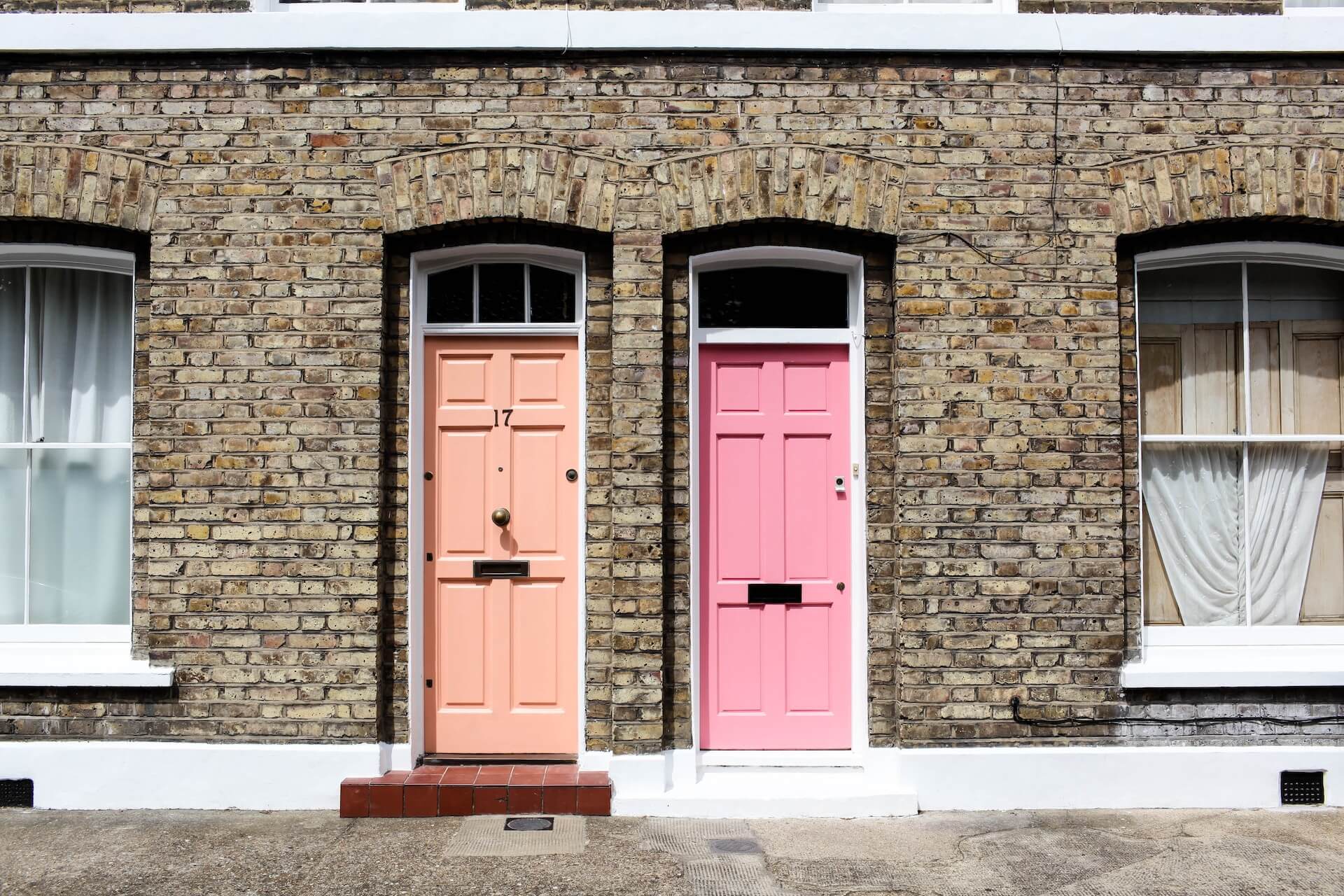 brick building with two different colored doors