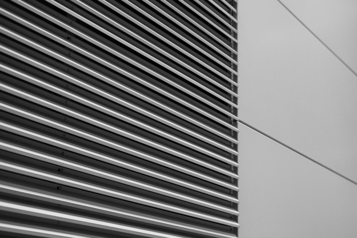 Black and white picture of the side of a building. Image by Unsplash