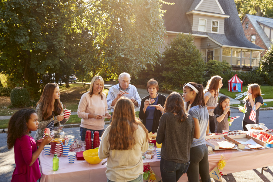 People standin up around a table, eating