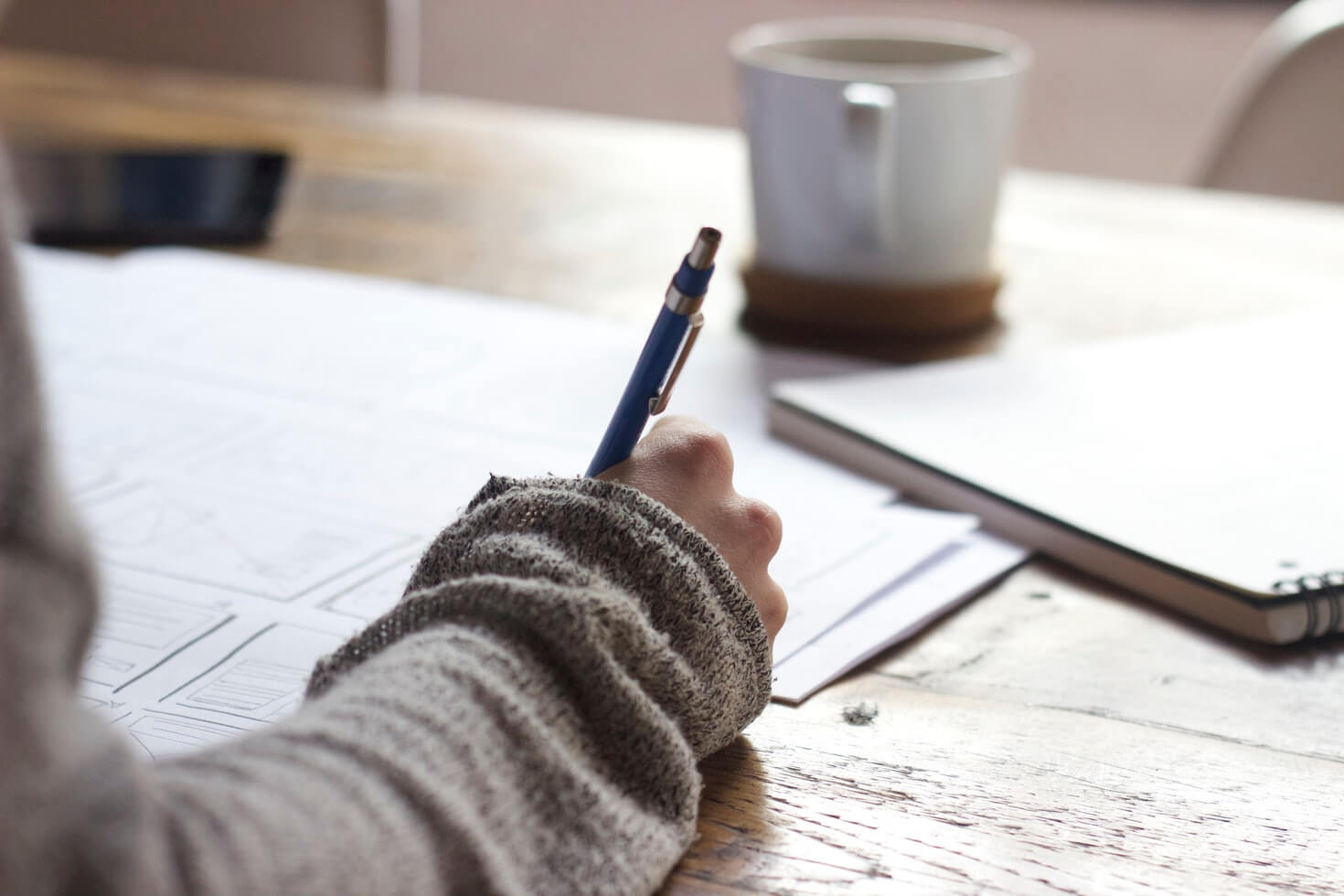 person writing on a paper