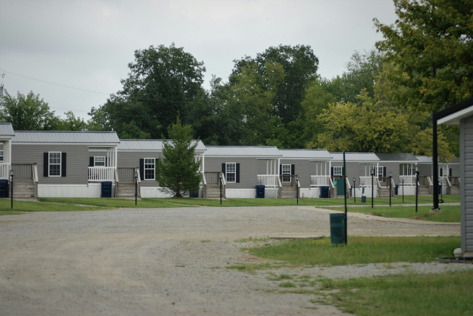 Multiple houses in a row. Trees behind the houses. Image by Unsplash