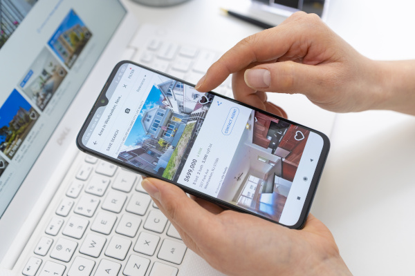 person looking at real estate listing on a cellphone