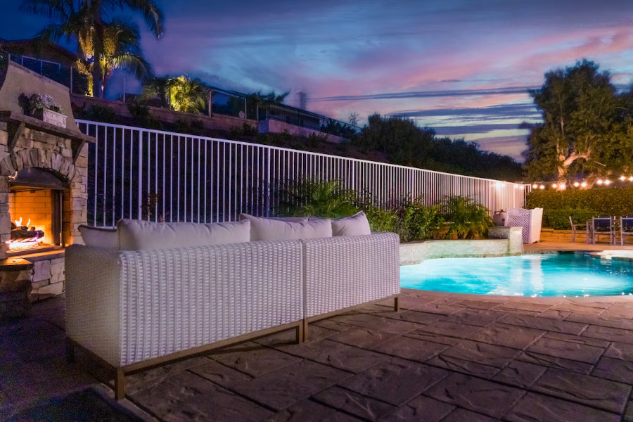 patio with a pool, sofia, fireplace