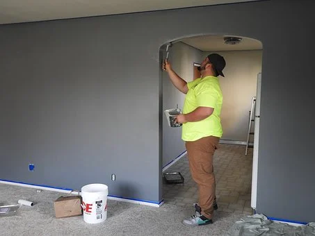 person painting a doorway