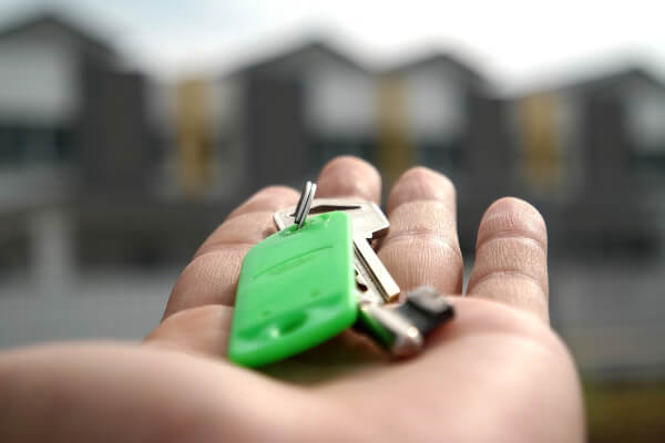 house in hand, person writing