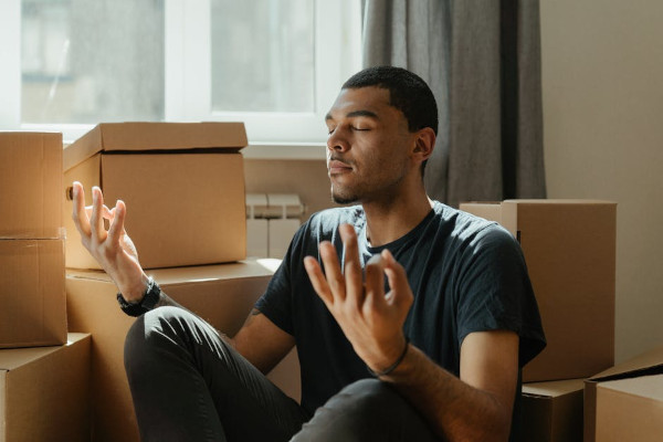 Person relaxing, boxes in background