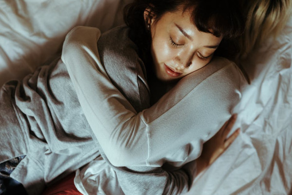 People hugging in a bed