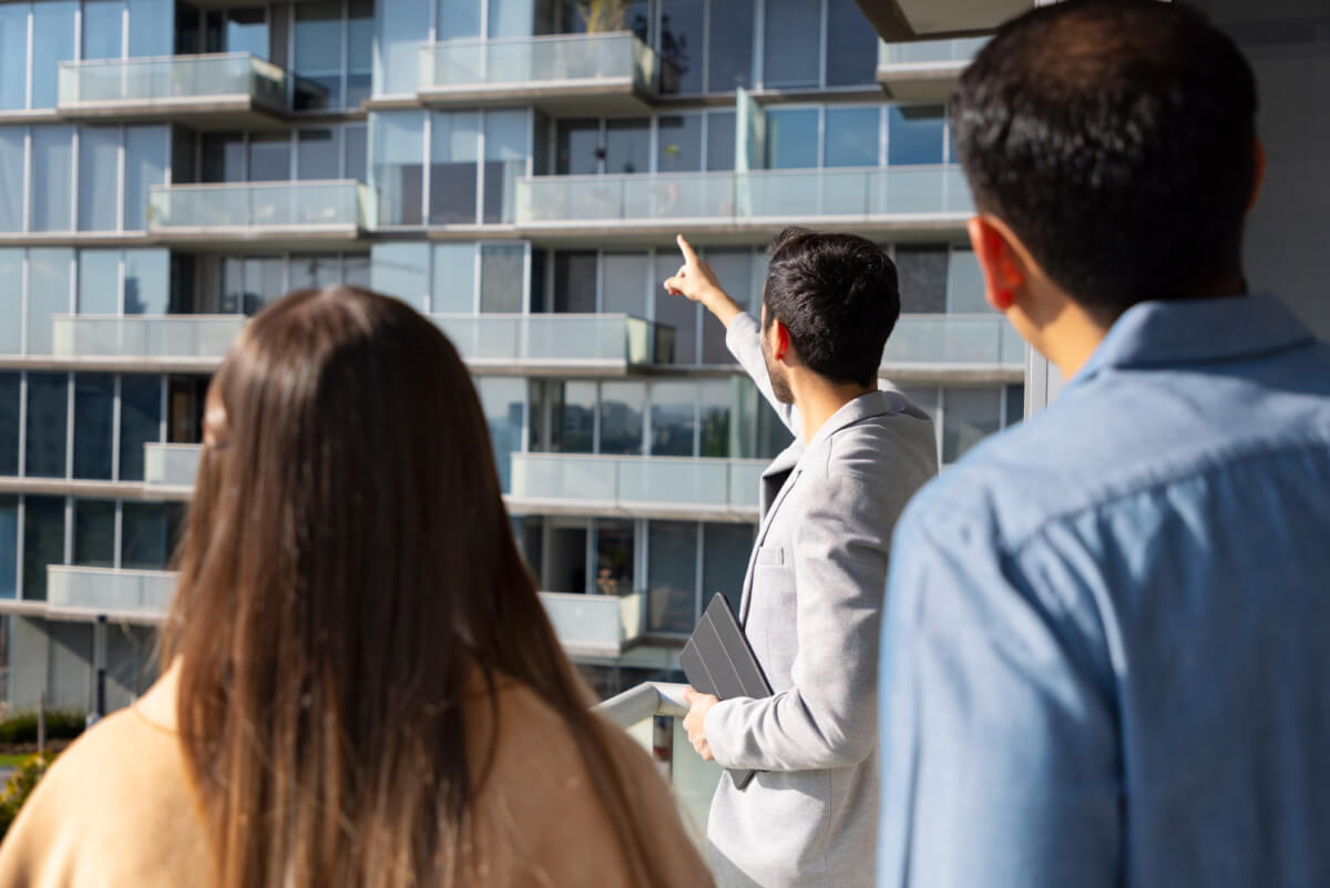 people talking to a real estate agent