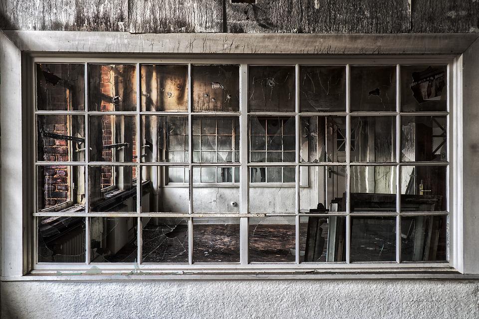 Looking through a window into a fire damaged house