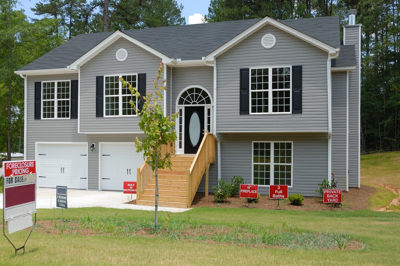 Gray house with lots of signs in the yard. Image by Pixabay