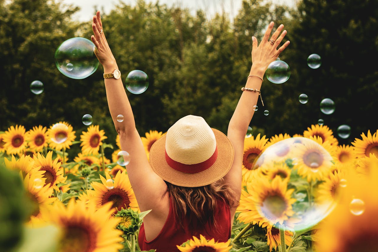 person surrounded by sunflowers