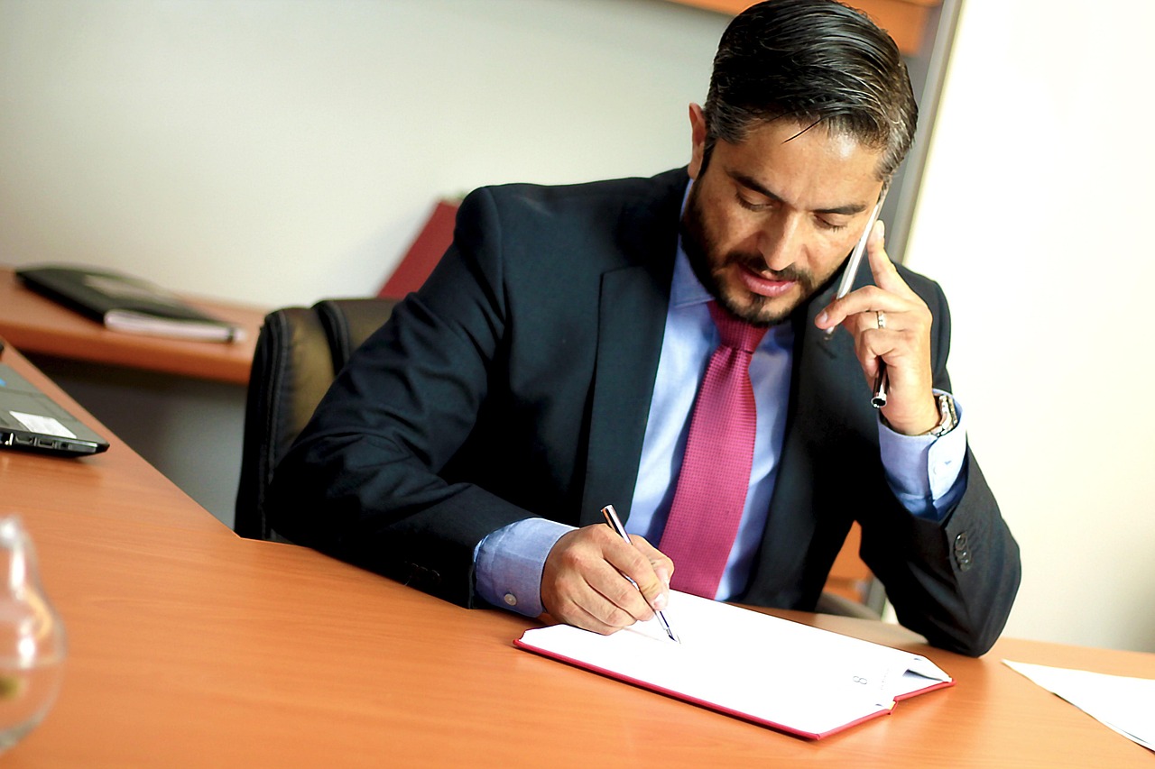 Person in a suit on the phone. Image by Pixabay
